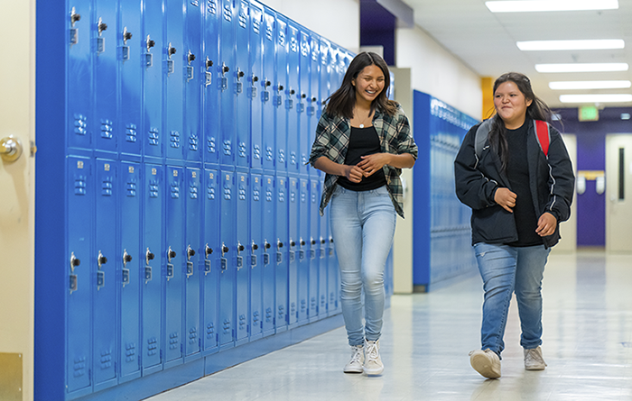 students walking down hall past lockers