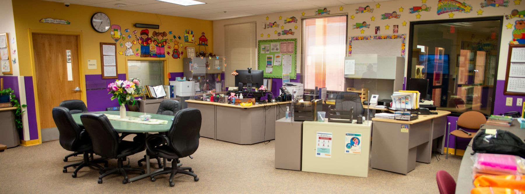 School office featuring a conference table and desks.